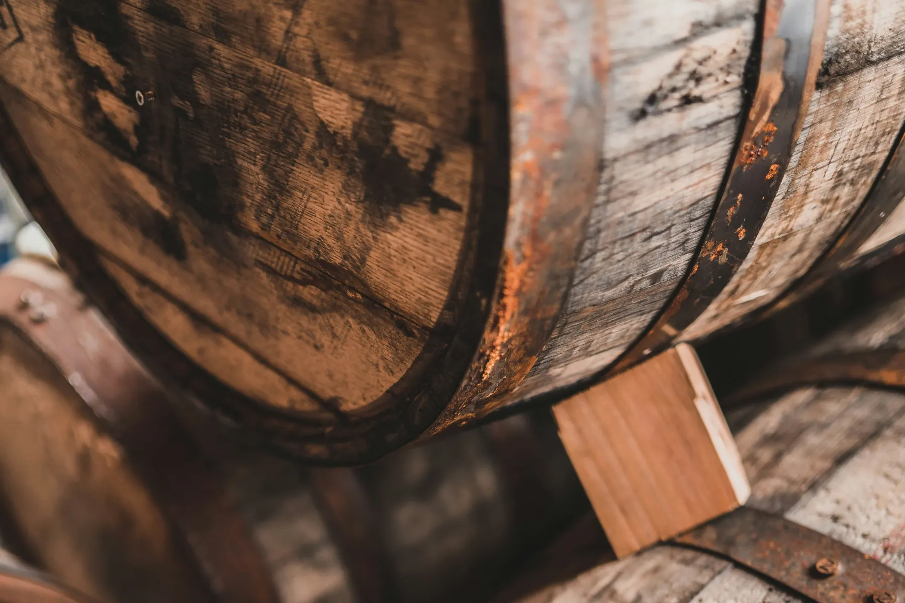 Oak whisky casks stacked in a warehouse